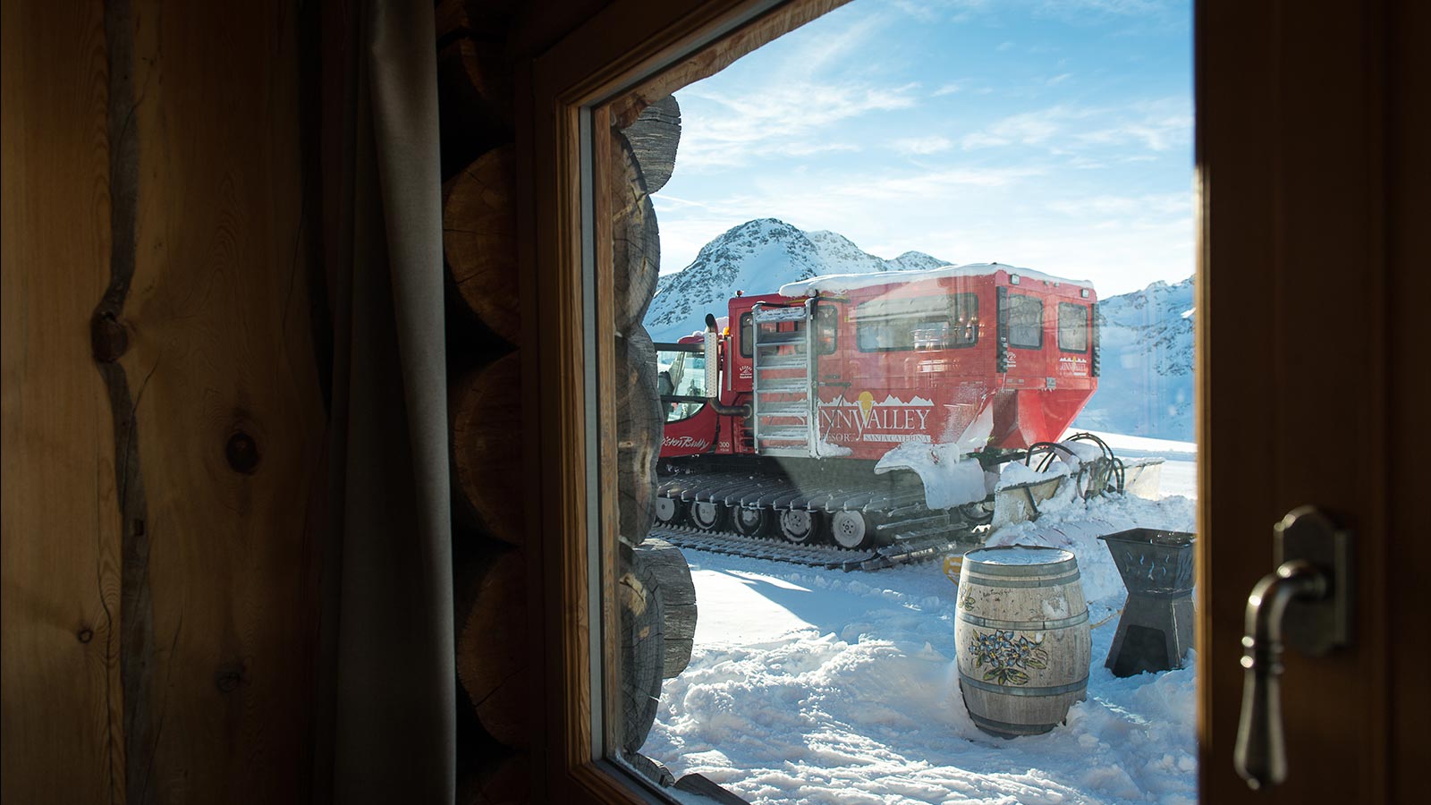 Snowplow at work outside the mountain lodge