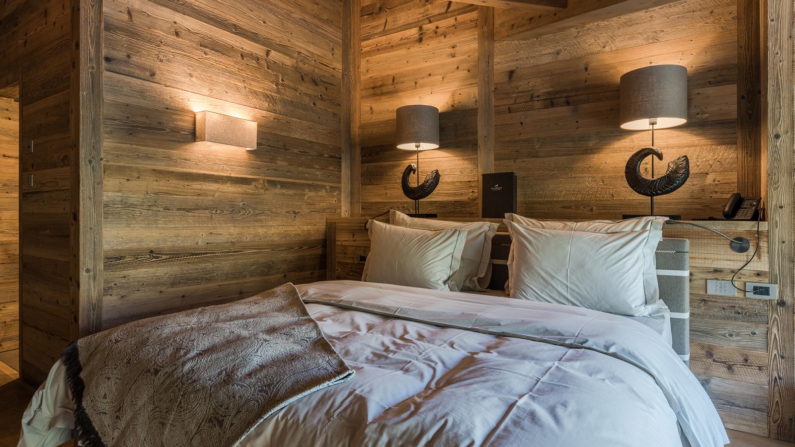 Detail of the bed of one of the suites at the Mountain Lodge